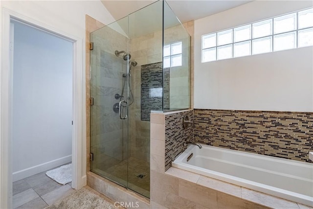 full bath with a bath, a shower stall, and tile patterned floors