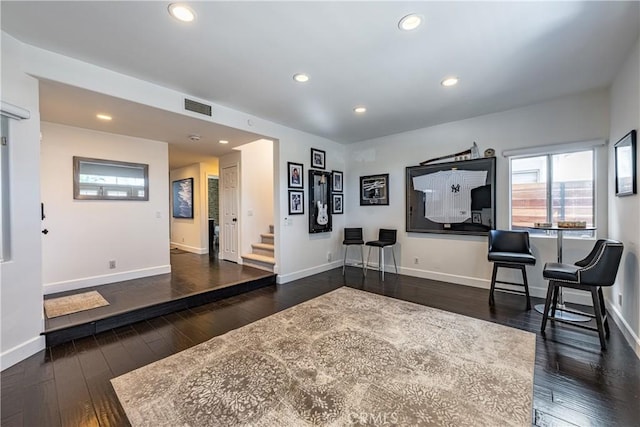 sitting room featuring visible vents, baseboards, stairway, hardwood / wood-style floors, and recessed lighting