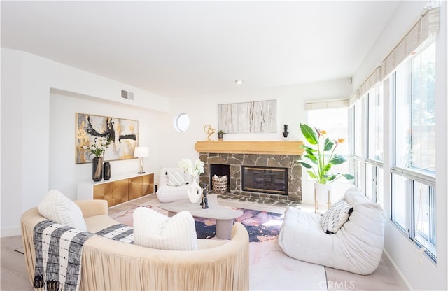 living room with visible vents, baseboards, and a fireplace