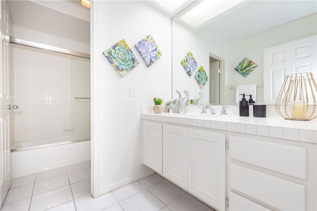 full bath featuring tile patterned flooring,  shower combination, vanity, and baseboards