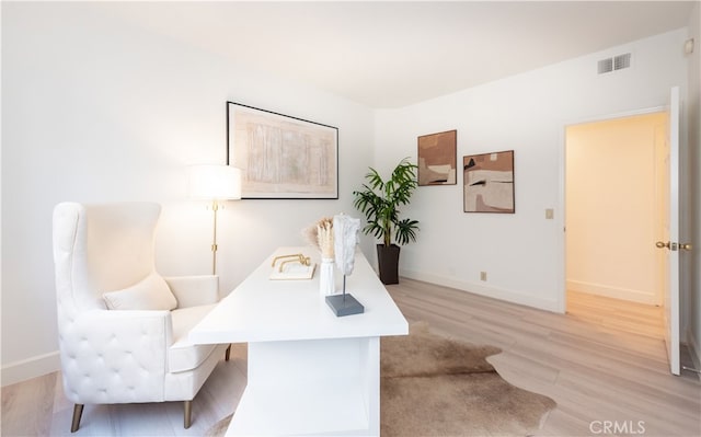 office area featuring visible vents, baseboards, and light wood-style floors