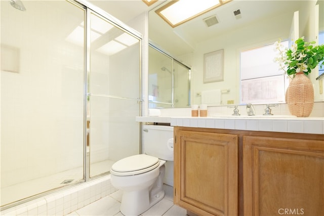 bathroom with visible vents, a shower stall, toilet, and vanity