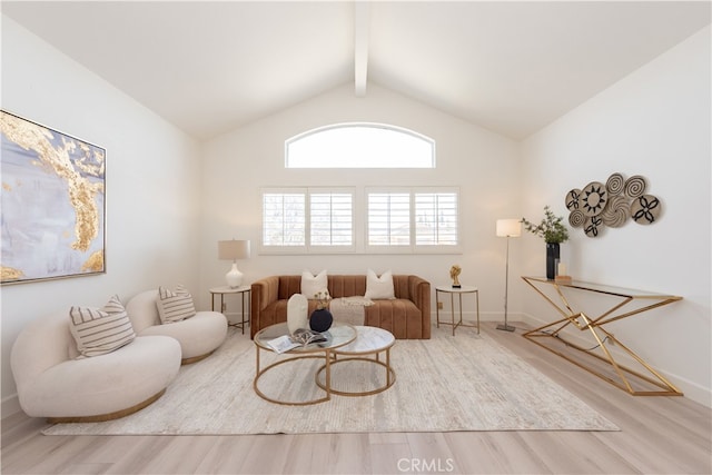 living room featuring lofted ceiling with beams and wood finished floors