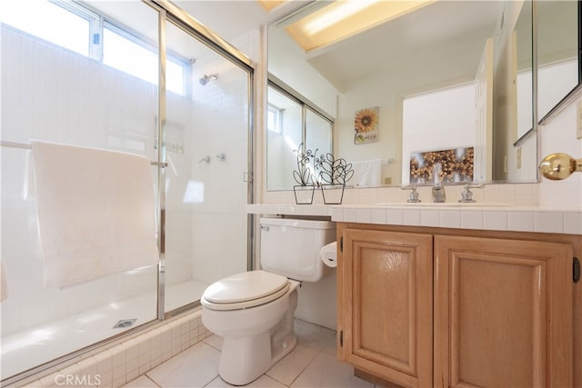 full bath with tile patterned flooring, a shower stall, toilet, and vanity