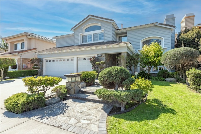 view of front facade featuring concrete driveway and a front lawn