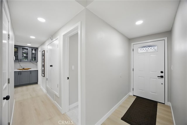 foyer featuring recessed lighting, baseboards, and light wood finished floors