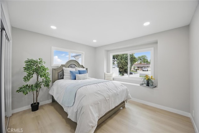 bedroom with recessed lighting, baseboards, and light wood-style flooring