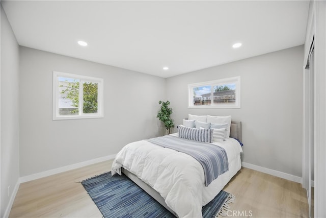 bedroom featuring recessed lighting, light wood-type flooring, and baseboards