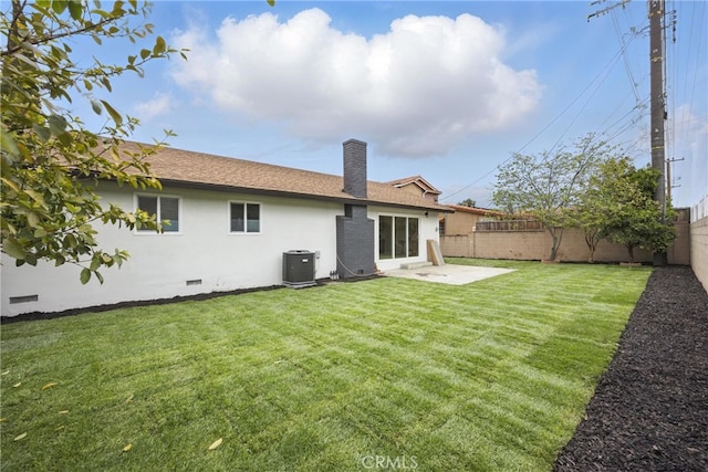 back of property with cooling unit, a fenced backyard, a chimney, and crawl space