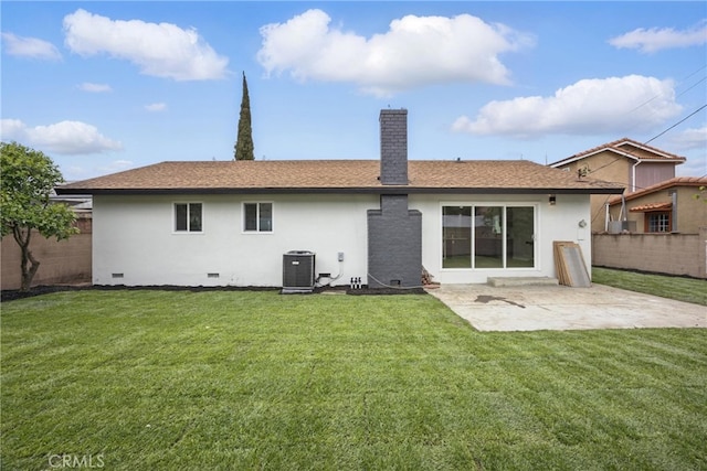 rear view of house featuring crawl space, a yard, a chimney, and fence