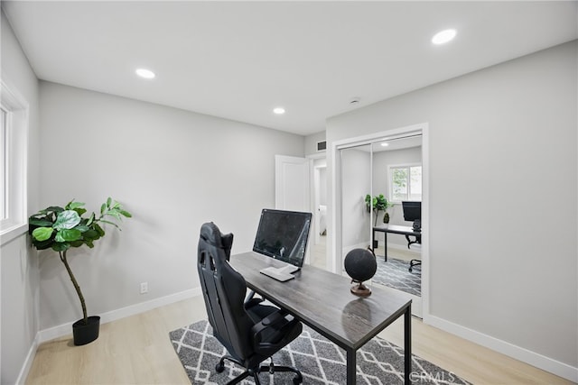 office featuring recessed lighting, baseboards, and light wood finished floors