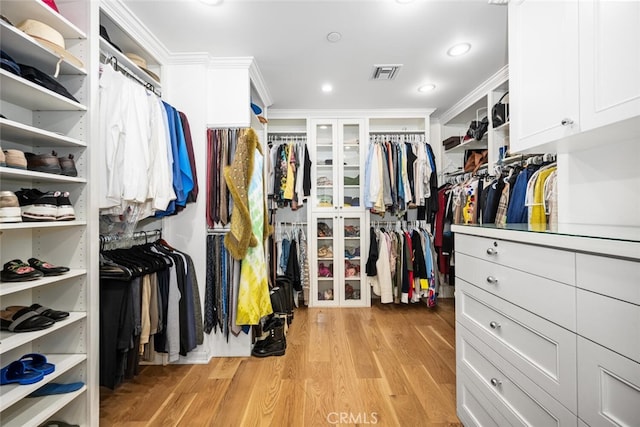 spacious closet with light wood-style floors and visible vents