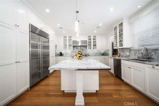 kitchen with a sink, stainless steel appliances, under cabinet range hood, and white cabinets