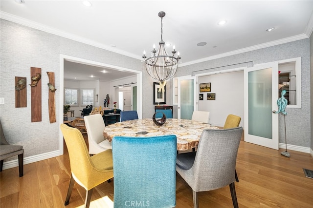 dining area with visible vents, ornamental molding, baseboards, and wood finished floors