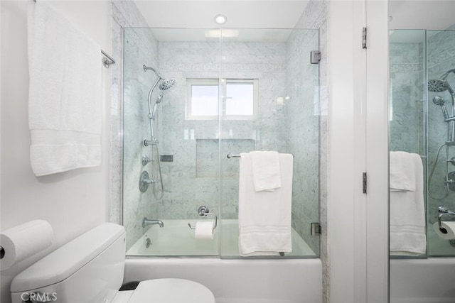 bathroom featuring toilet and enclosed tub / shower combo