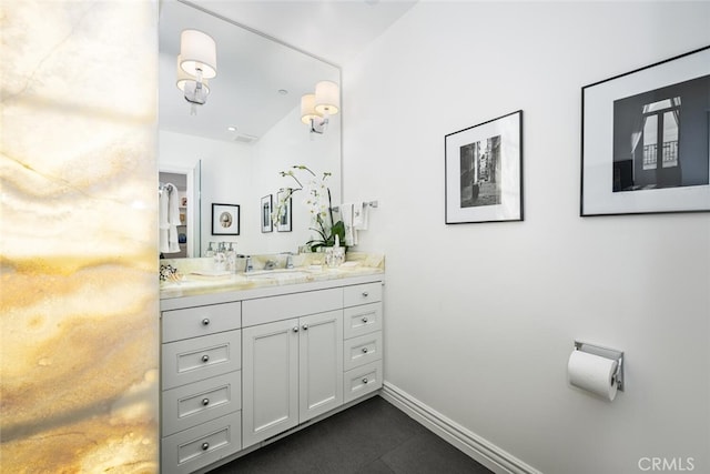 bathroom with vanity and baseboards