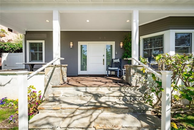 view of exterior entry featuring a porch