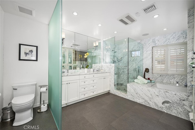 bathroom with a marble finish shower, visible vents, toilet, and double vanity