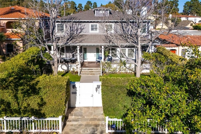 view of front facade with a fenced front yard, a porch, and a gate