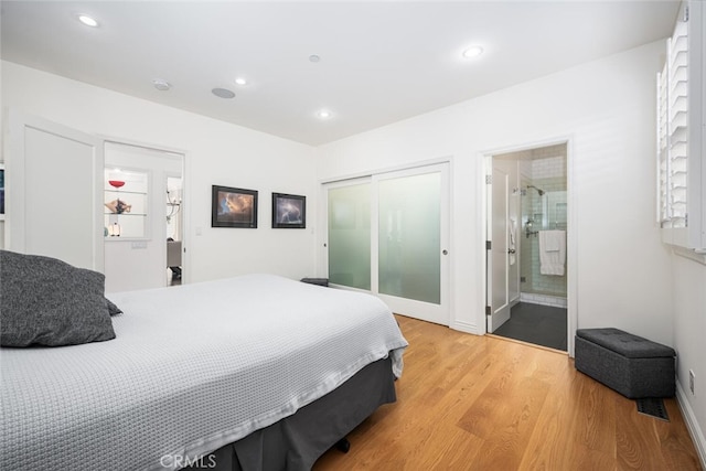 bedroom with recessed lighting, light wood-style floors, a closet, and baseboards