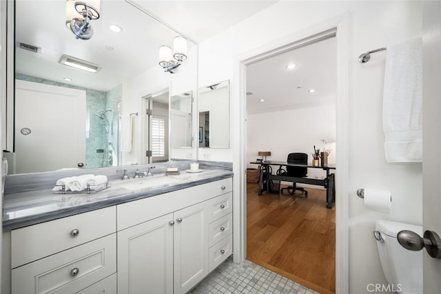 bathroom featuring visible vents, a stall shower, wood finished floors, recessed lighting, and vanity