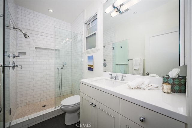 bathroom with visible vents, a shower stall, toilet, and vanity