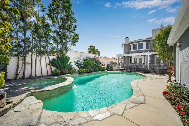 view of pool with a patio area, a fenced backyard, and a pool with connected hot tub