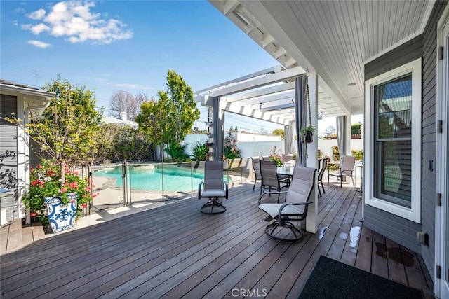 deck with outdoor dining space, a fenced in pool, a pergola, and fence