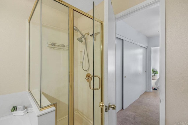 bathroom with a tub to relax in and a stall shower