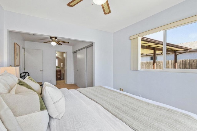 bedroom with a closet, ensuite bathroom, and a ceiling fan