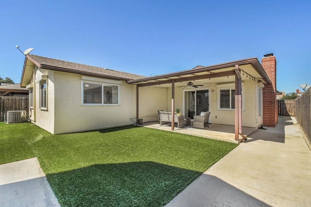 rear view of property with a ceiling fan, a fenced backyard, stucco siding, a patio area, and an outdoor hangout area