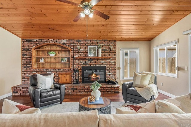 living area featuring wood finished floors, a brick fireplace, wood ceiling, and baseboards