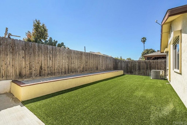 view of yard featuring central air condition unit and a fenced backyard