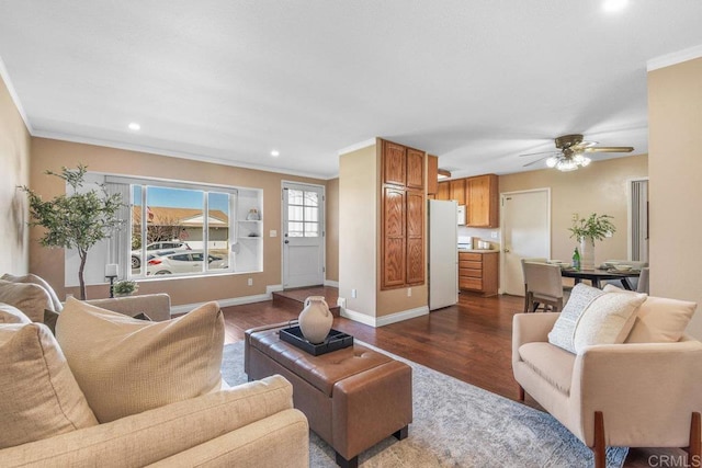 living area featuring dark wood-style floors, baseboards, recessed lighting, ceiling fan, and ornamental molding