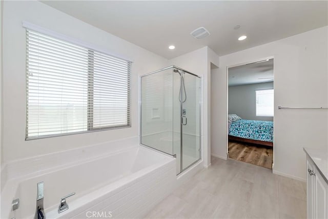 full bathroom with visible vents, a shower stall, recessed lighting, a bath, and ensuite bath