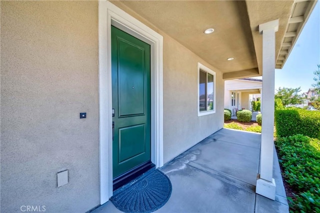 property entrance with stucco siding