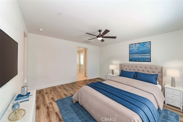 bedroom with wood finished floors, baseboards, and ceiling fan