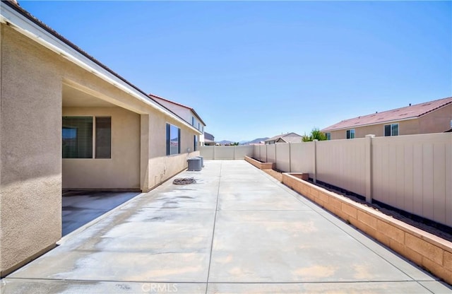 view of patio / terrace featuring central air condition unit and a fenced backyard