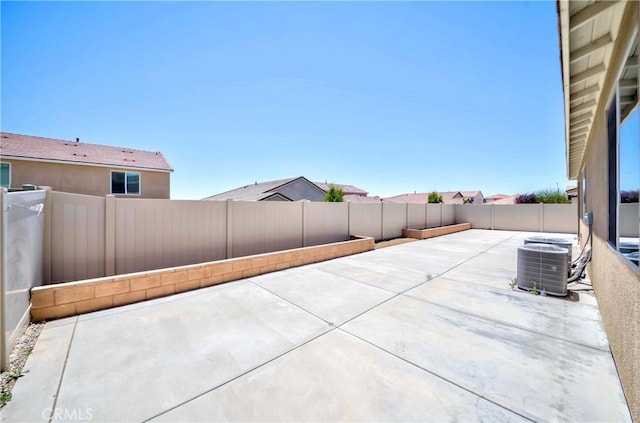 view of patio with central air condition unit and a fenced backyard