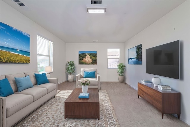 living room with visible vents, a healthy amount of sunlight, baseboards, and carpet floors