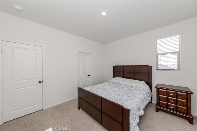 bedroom featuring baseboards and light carpet