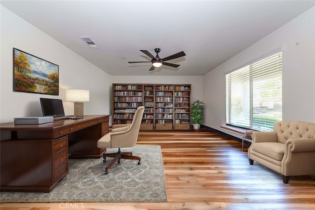 office area with visible vents, wood finished floors, and a ceiling fan