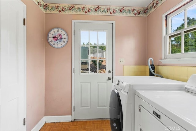 washroom featuring laundry area, independent washer and dryer, and baseboards