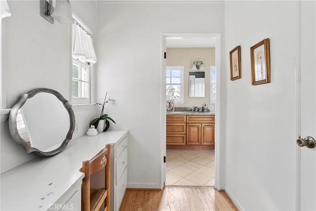 bathroom with vanity, baseboards, and wood finished floors