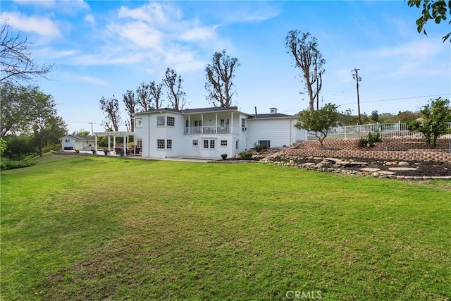 rear view of property with a yard, fence, and a patio area