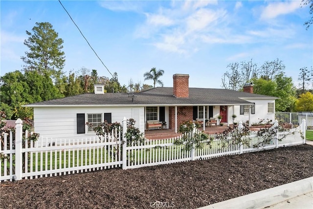 single story home featuring a fenced front yard, a porch, and a chimney