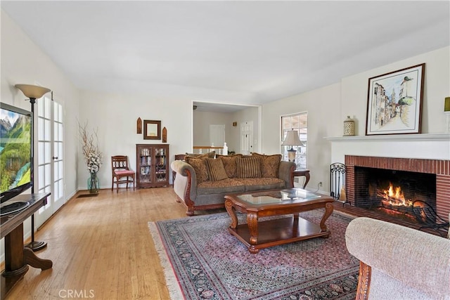 living area with a fireplace and light wood finished floors