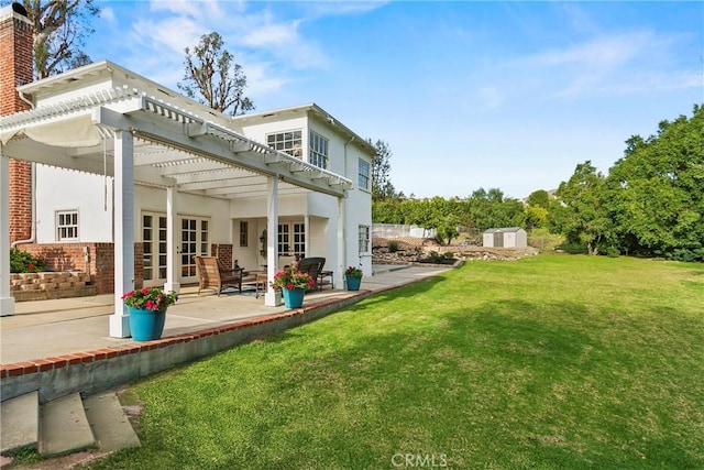 rear view of property with a patio, an outbuilding, a pergola, a chimney, and a lawn