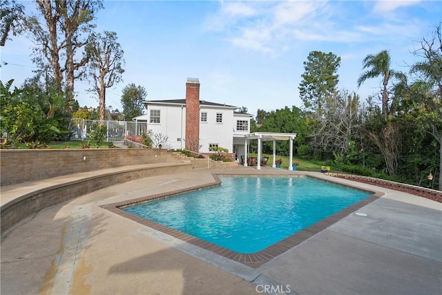 pool featuring a patio and fence