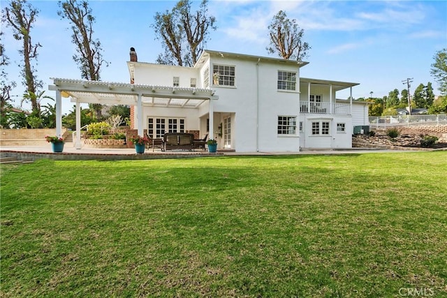 rear view of house with a yard, a patio, fence, and a pergola